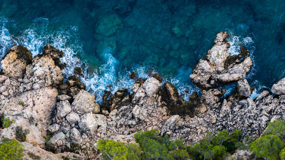 A breathtaking aerial view of the rocky coastline and blue waters in Marseille, France.