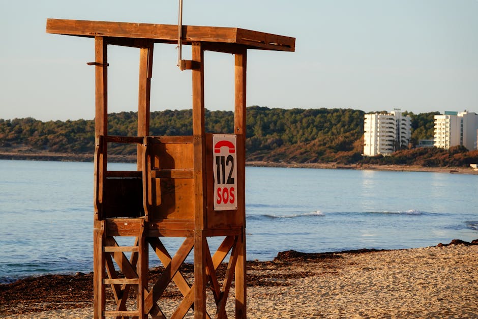 A serene view of the lifeguard tower on Cala Millor beach, Spain, during summer.