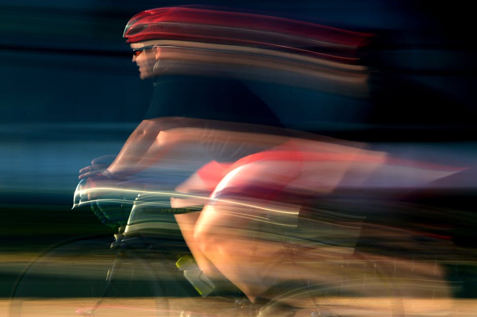 A cyclist in motion blur creates a dynamic and energetic photograph.