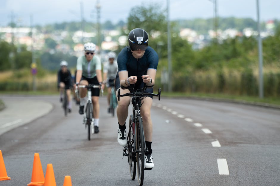 Cyclists racing on an open road in scenic Jönköping, Sweden, during a summer competition.