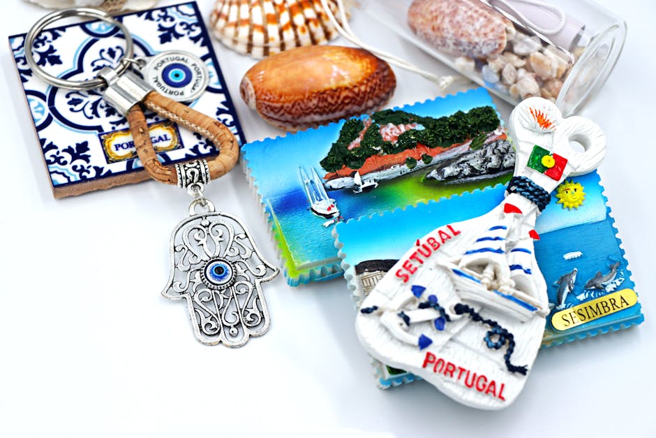 A vibrant collection of Portuguese souvenirs including keychains and magnets showcasing Setúbal and Sesimbra.