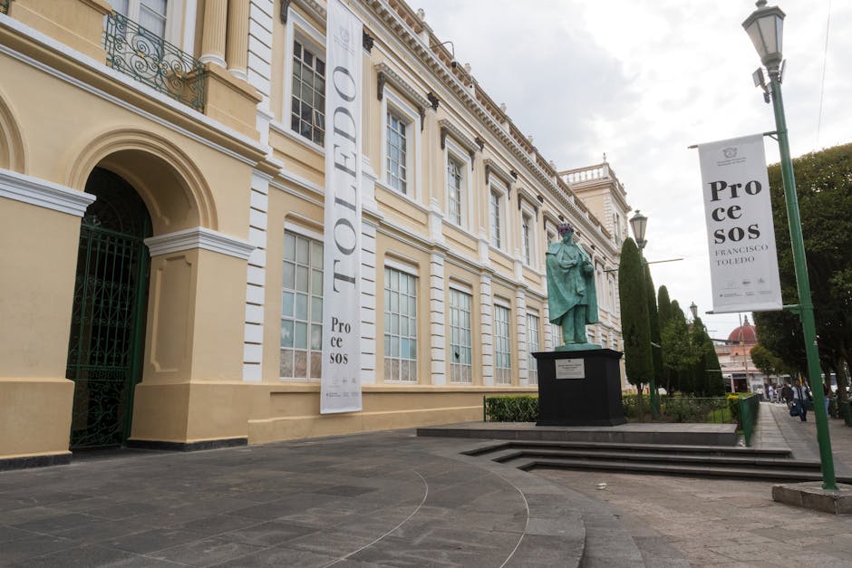 Elegant historic building with statue in Toluca de Lerdo, Mexico, showcasing cultural architecture.