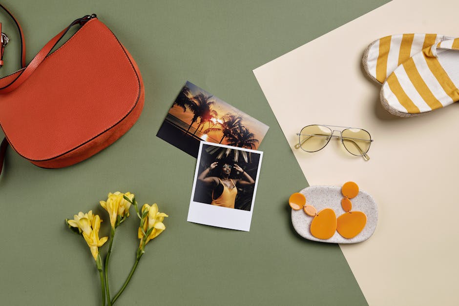 Stylish summer accessories and polaroid photos arranged on a green background.