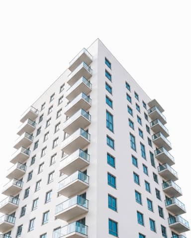 Modern White Apartment Building Exterior with Glass Balconies