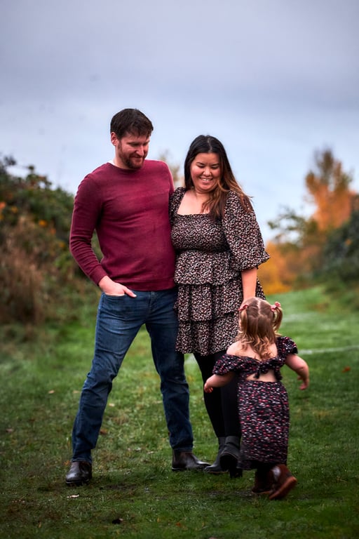 Relaxed outdoor family group portrait in soft natural light