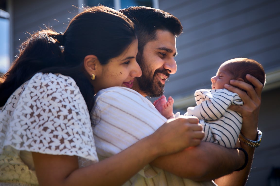 Family sharing a warm group embrace during their session