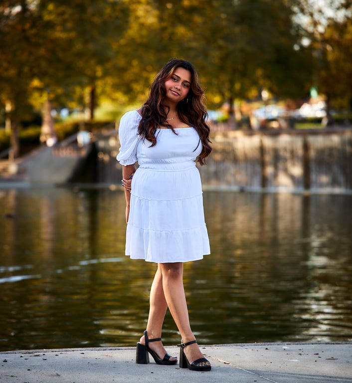 Expressive portrait with bold eye contact and a natural backdrop