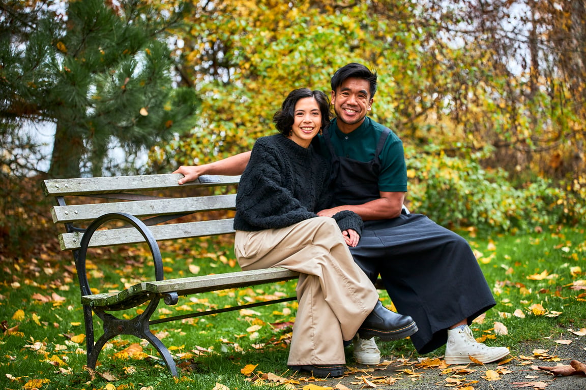 Couple embracing within a sunlit Pacific Northwest setting