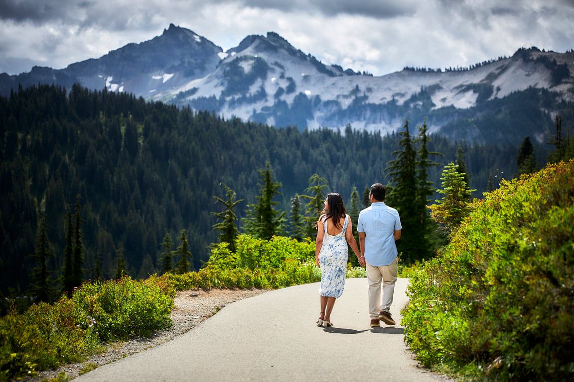 Couple standing close together in a lush natural forest setting