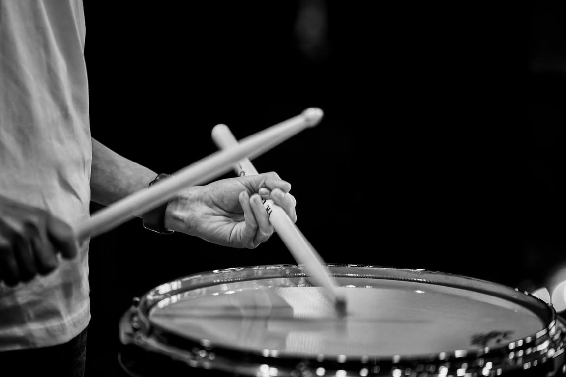 Performer drumming with expressive movement on stage