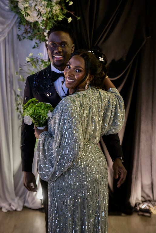 Bride and groom posed together in ornate wedding attire