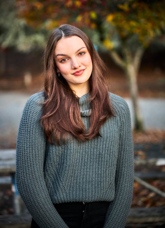 Clean professional headshot with gentle expression and soft lighting