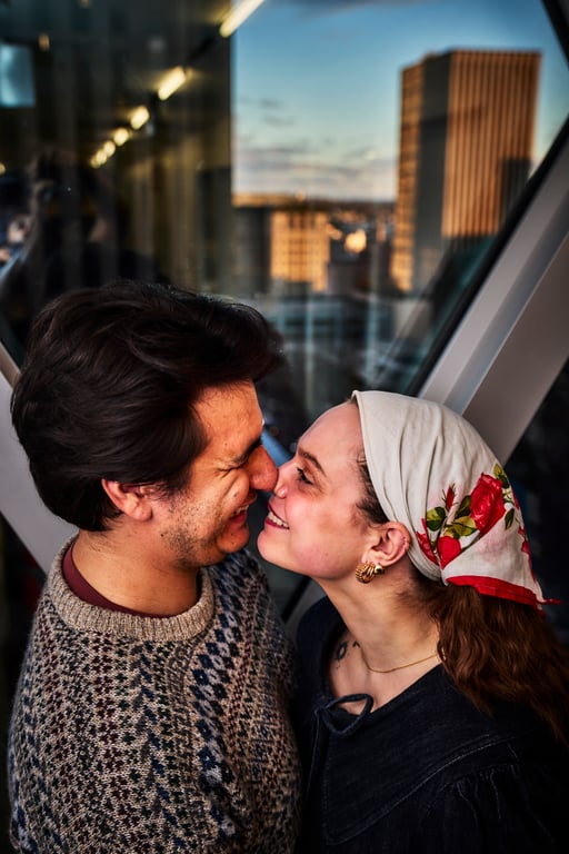 Couple looking at each other with genuine smiles outdoors