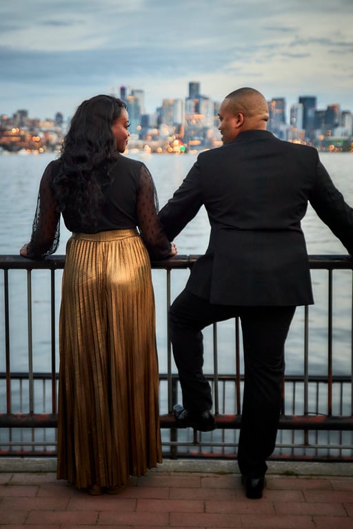 Couple posed together within a scenic tree-lined park setting