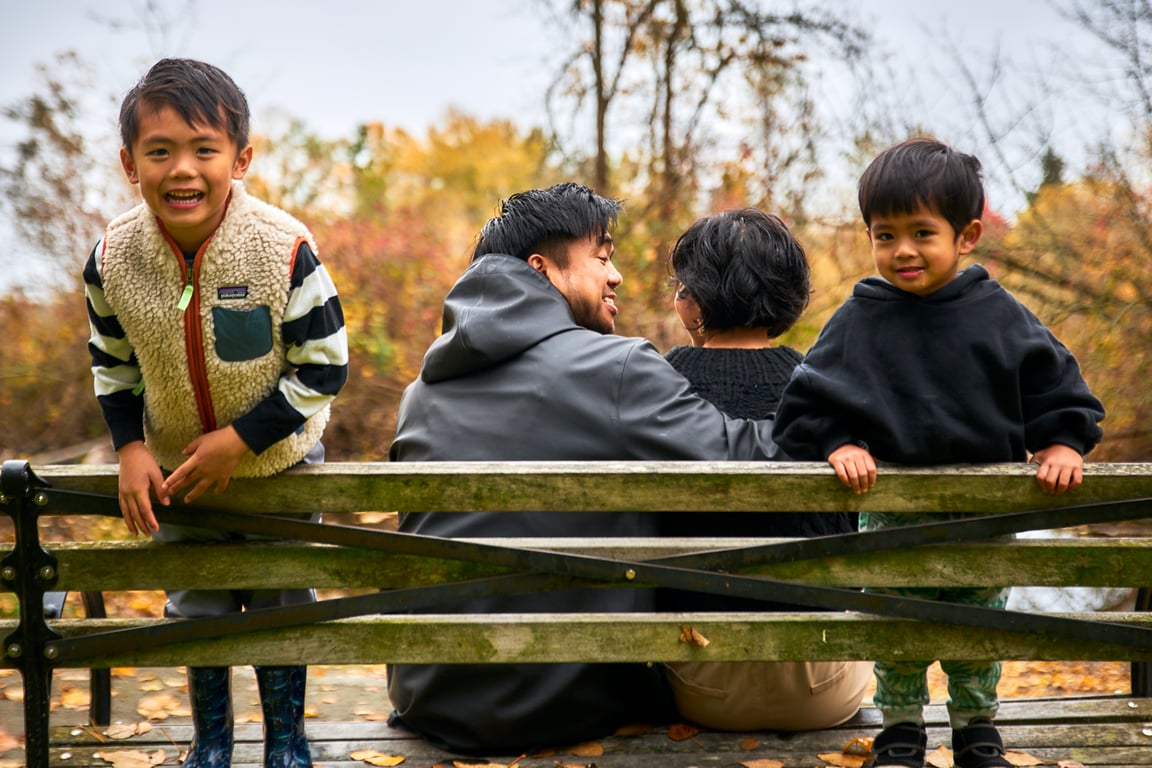 Family sharing a tender group embrace during their outdoor session