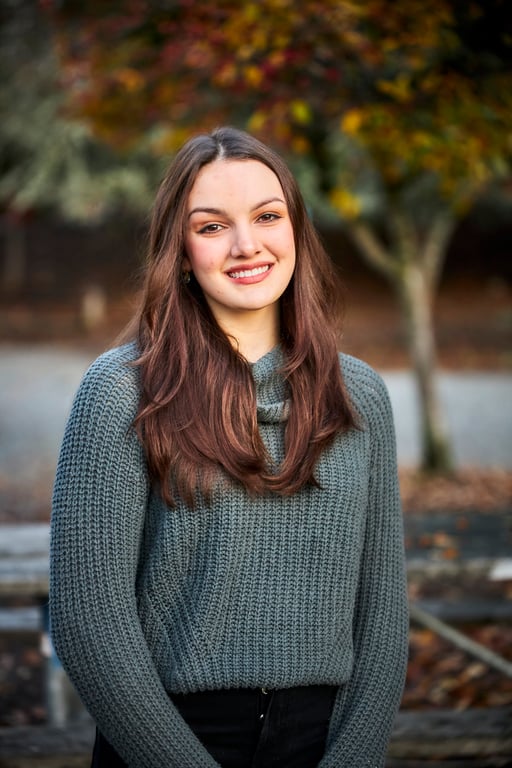 Portrait framed by natural elements under diffused daylight