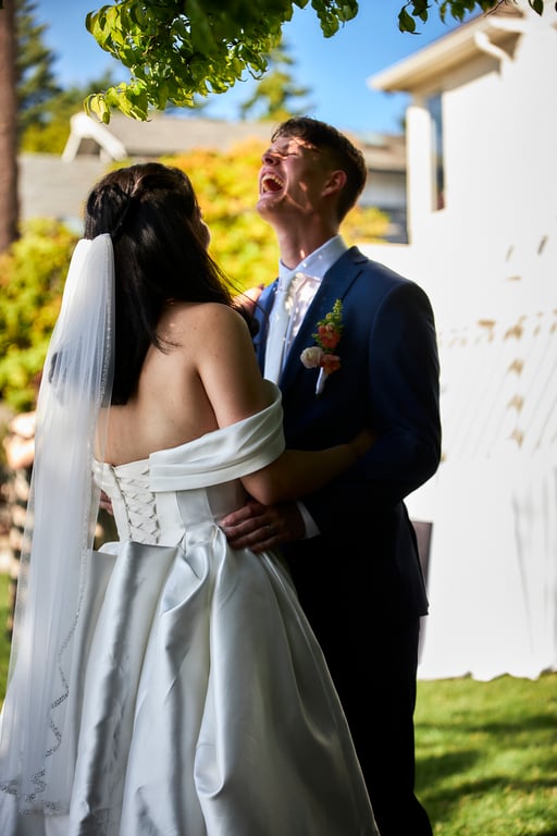 Bride and groom posed together in elegant wedding attire