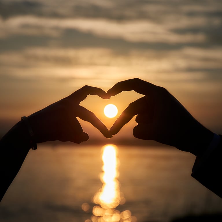 Couple leaning in close under soft golden hour glow