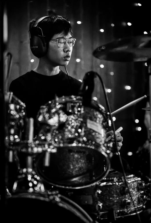 Close-up action shot of a drummer playing with intensity
