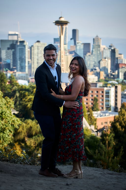 Couple posed together in front of a lush outdoor backdrop