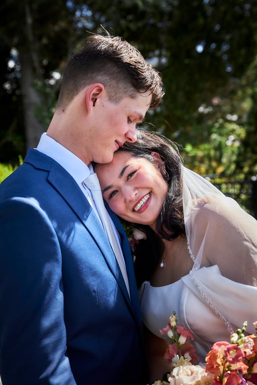 Candid wedding moment of the couple laughing together