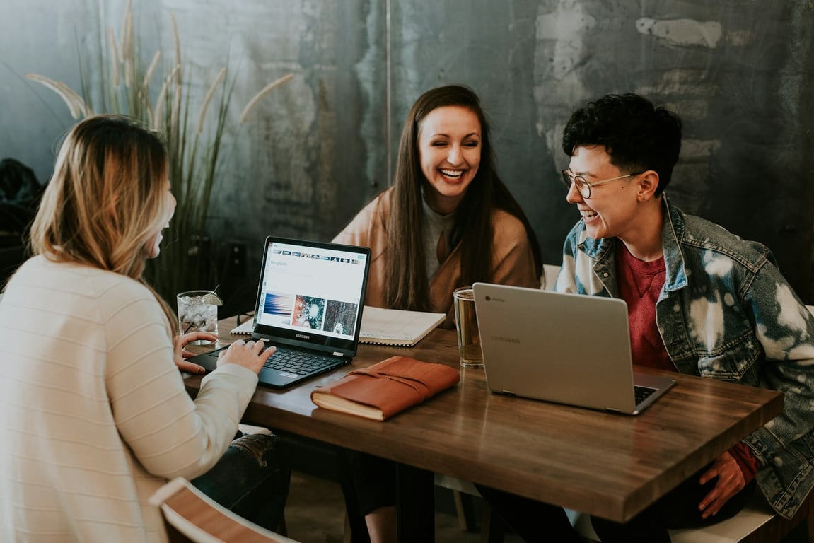 People learning together around laptops