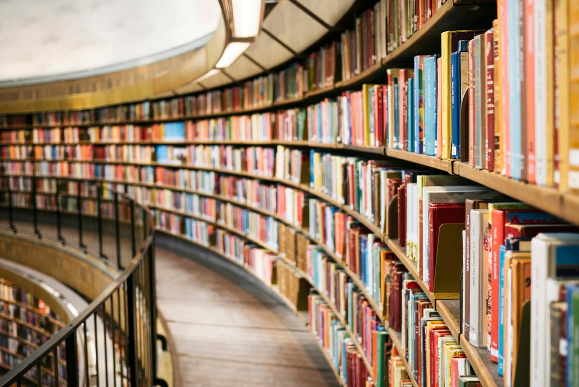 Sunlit library aisle filled with books