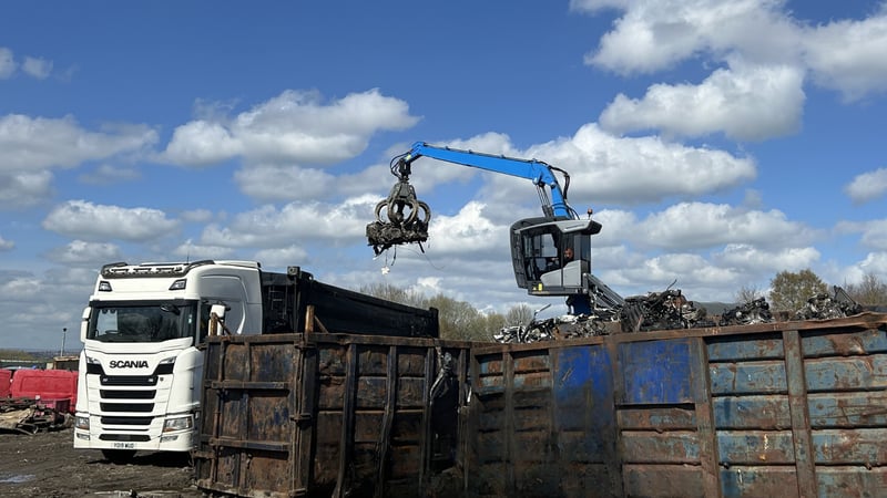 Crane loading scrap metal into artic bulker