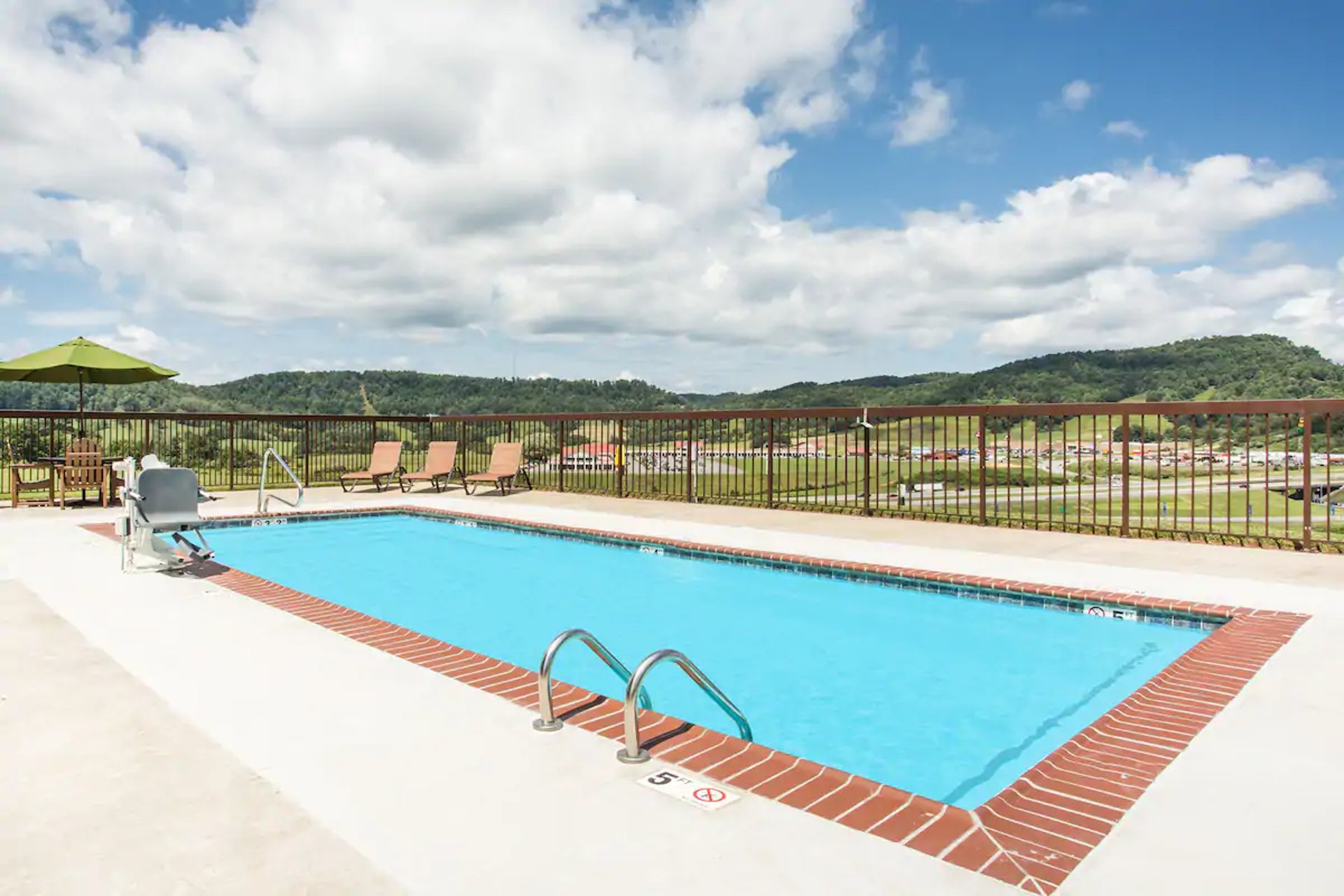 Outdoor pool | Days Inn & Suites by Wyndham Sutton Flatwoods