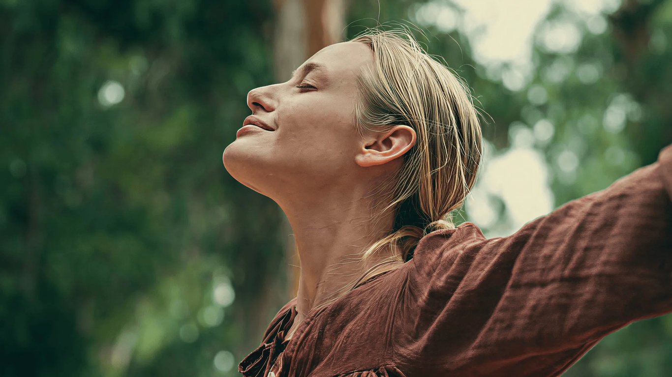 Woman with her face raised to the sun