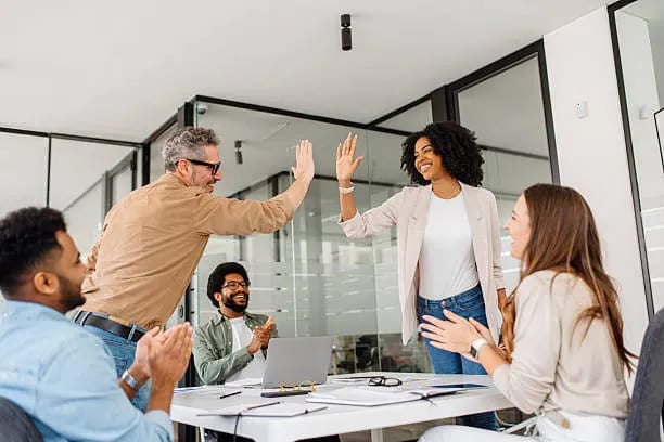 Partner team celebrating growth in a meeting