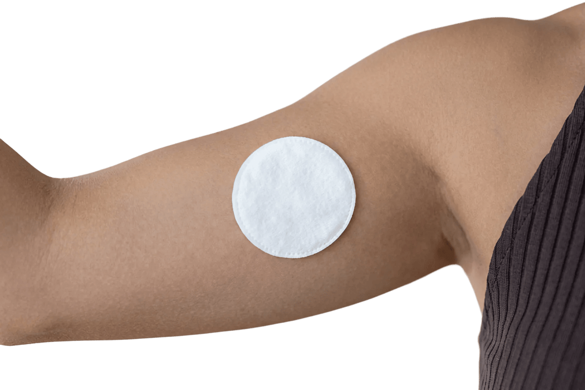 Arm with a cotton pad after an at-home blood draw