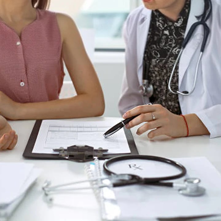 Clinician reviewing paperwork with a patient