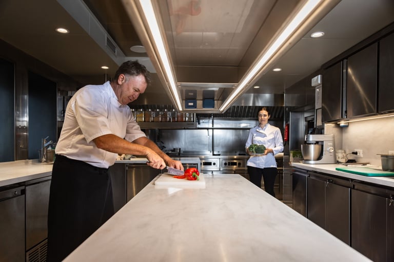Two chefs cooking together in the kitchen