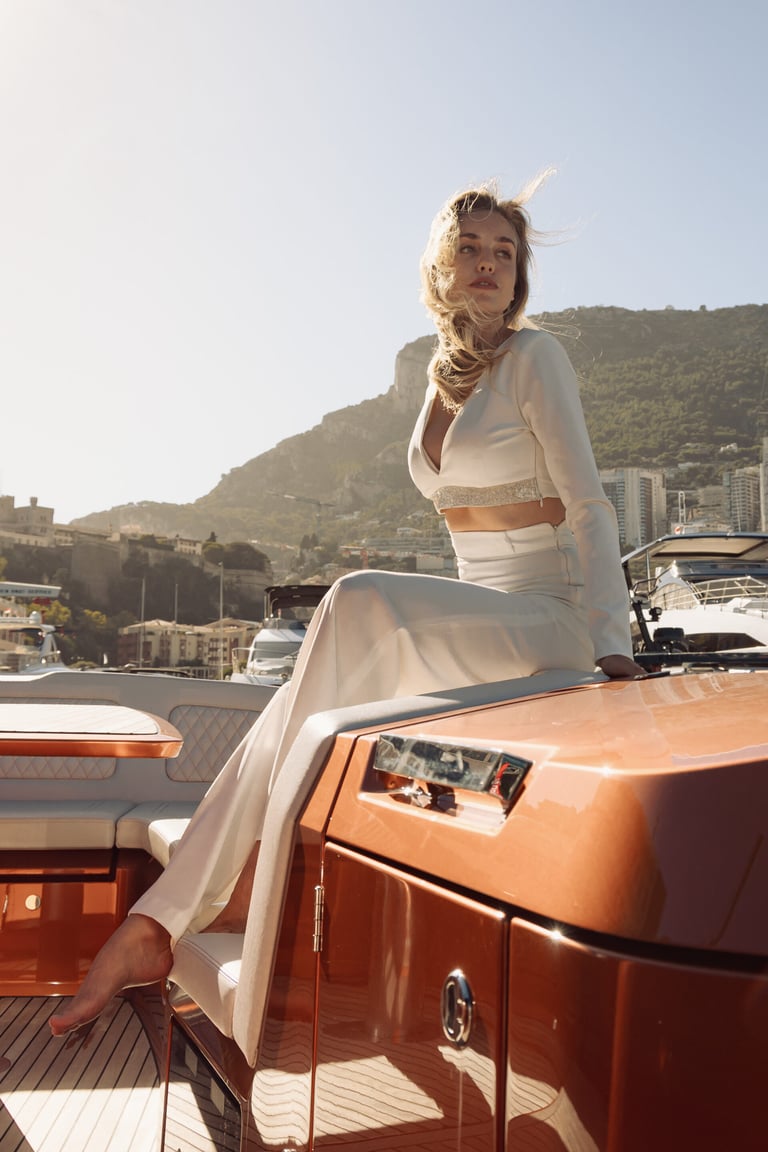 Blonde woman in a white dress on a boat