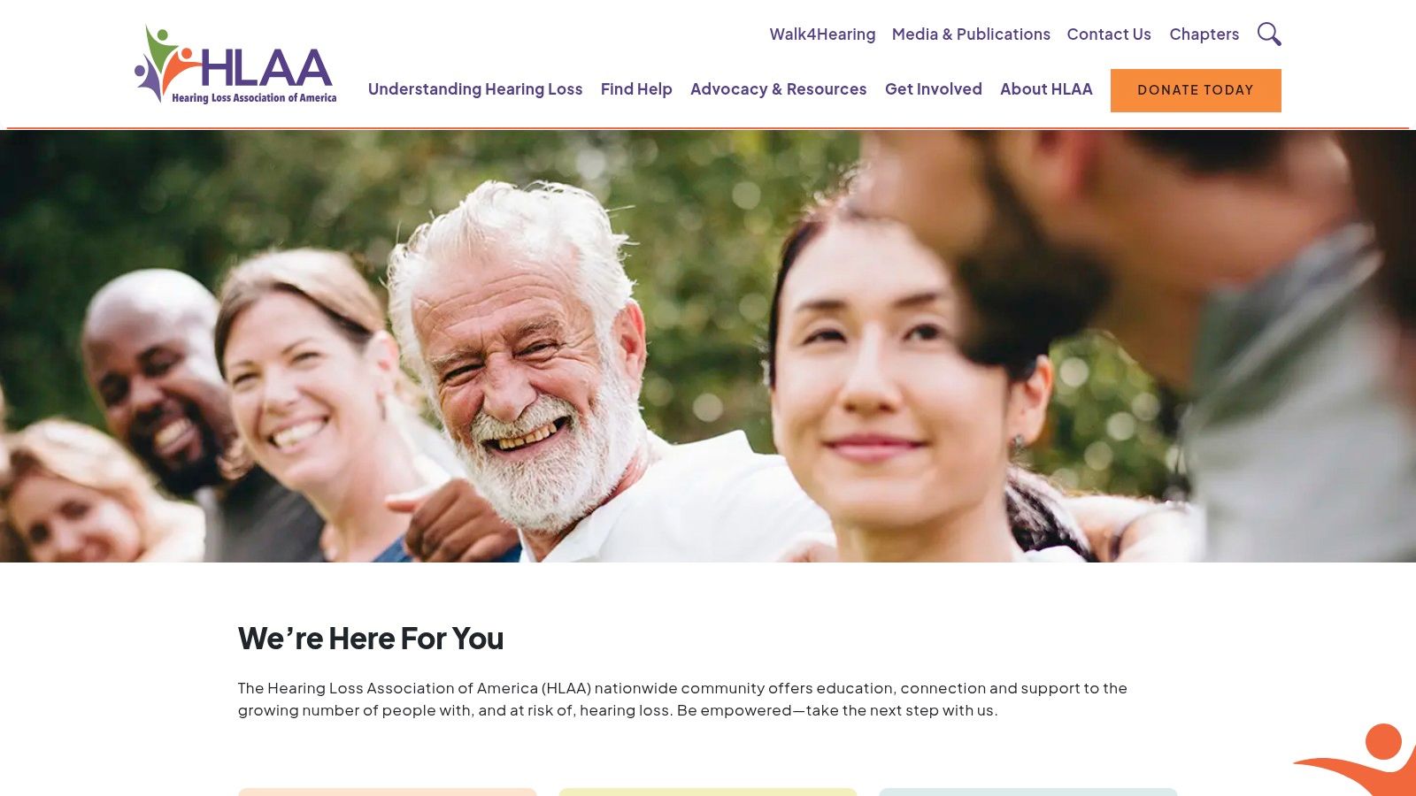 A diverse group of adults in a meeting, with some wearing hearing aids, actively listening and engaging in a discussion, representing an HLAA chapter meeting.