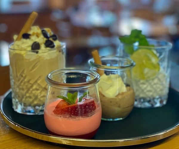Homemade desserts in jars: strawberry mousse, chocolate dream and lemon crumble.