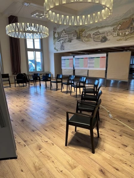 In a semicircle, everyone can see the presentation while still being able to talk to each other.