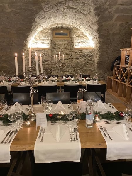 In the wine cellar, there's a rustic yet elegant atmosphere. Perfect for a successful company Christmas party.