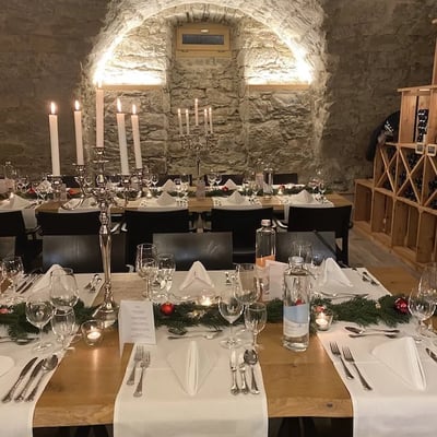 In the wine cellar, there's a rustic yet elegant atmosphere. Perfect for a successful company Christmas party.