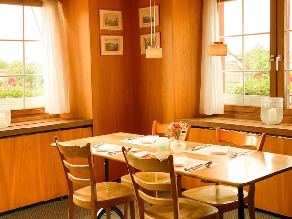 Cozy dining room at the Lion with warm wood paneling