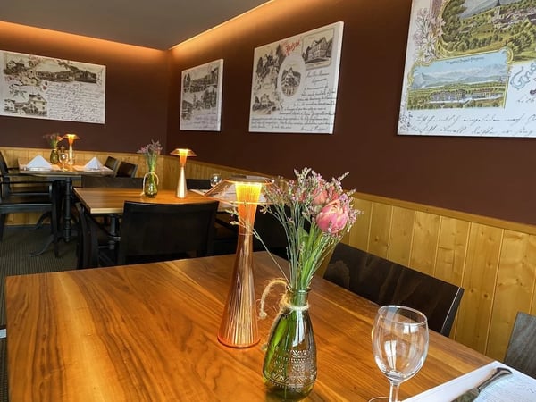 Cozy dining room in the evening with historic postcard motifs from the region