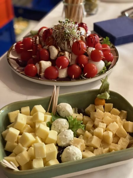 Caprese skewers with cherry tomatoes and mozzarella, decorated with microgreens.