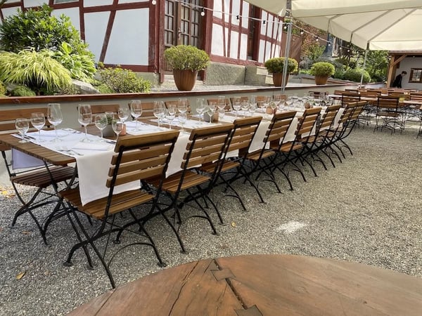 Festively set long table for groups in the beer garden in the summer