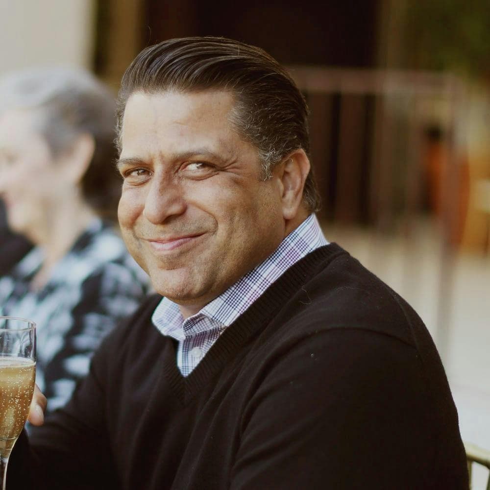 Casual outdoor portrait of a man in a Grand staff polo.