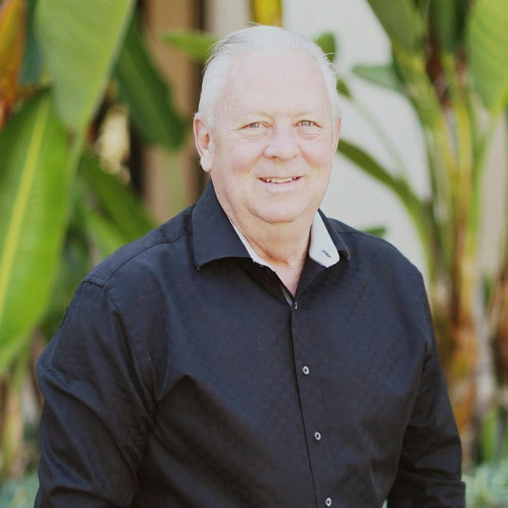 Portrait of a woman in a black blazer (team headshot).