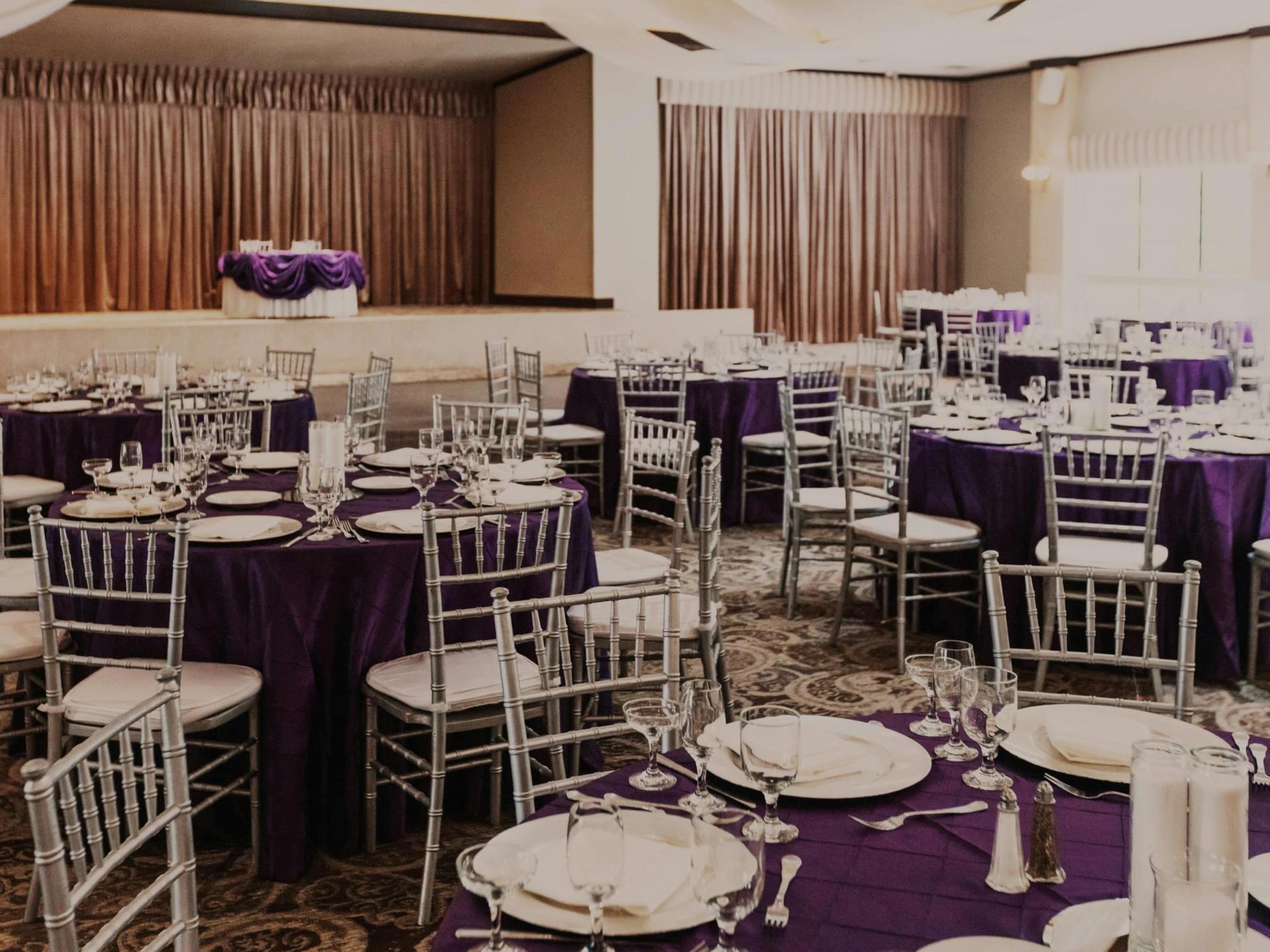 Grand Ballroom from rear or balcony: full room, stage, crystal lighting.