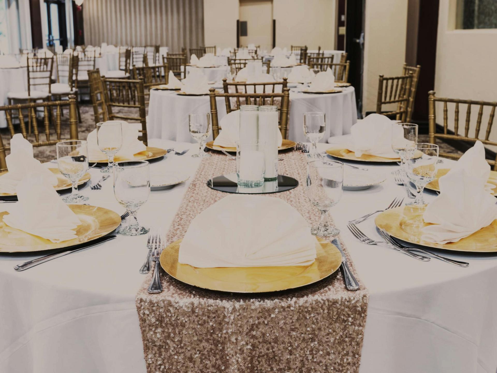 Garden Room with botanical wall, chandeliers, and set tables.
