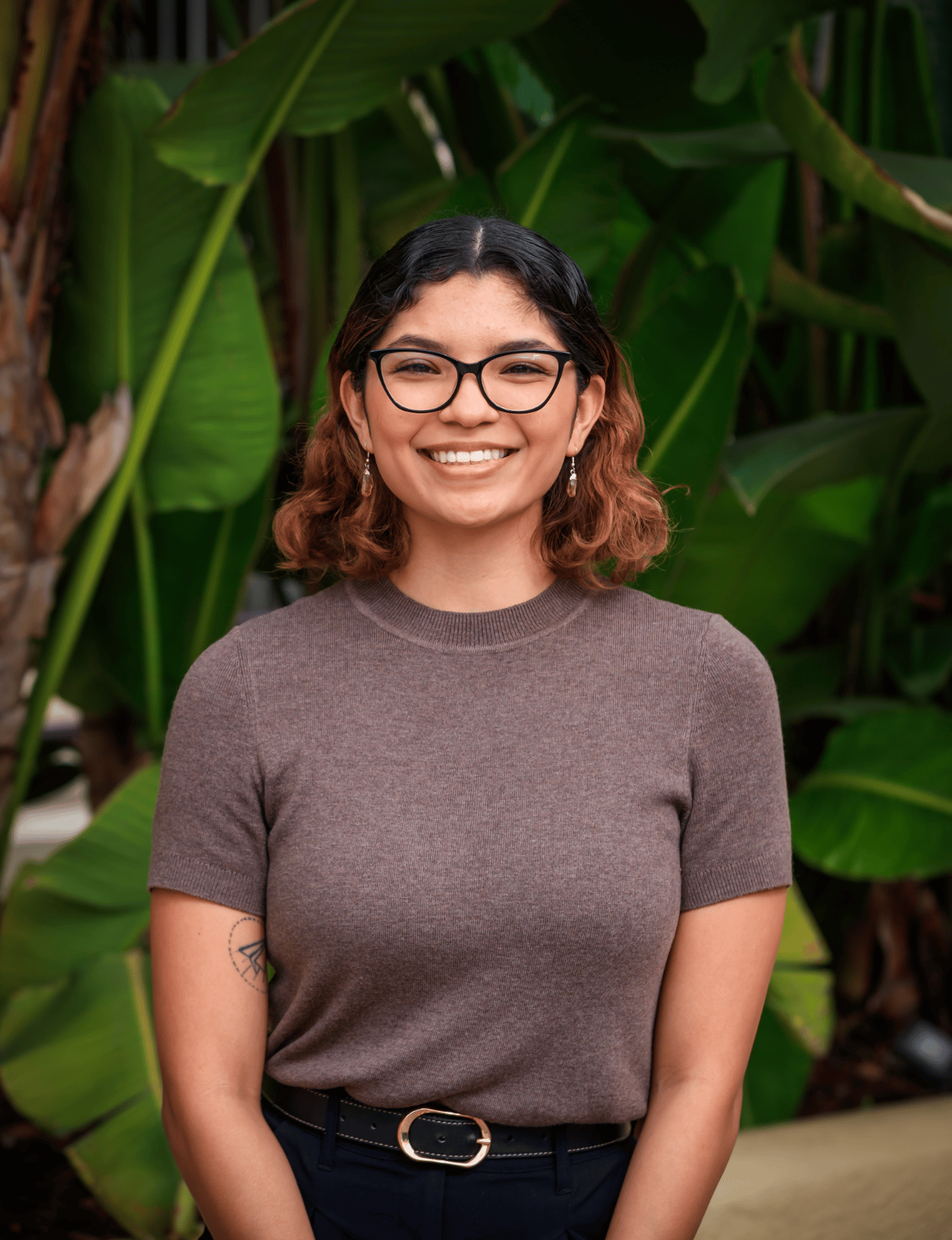 Portrait of a woman in a black blazer (team headshot).