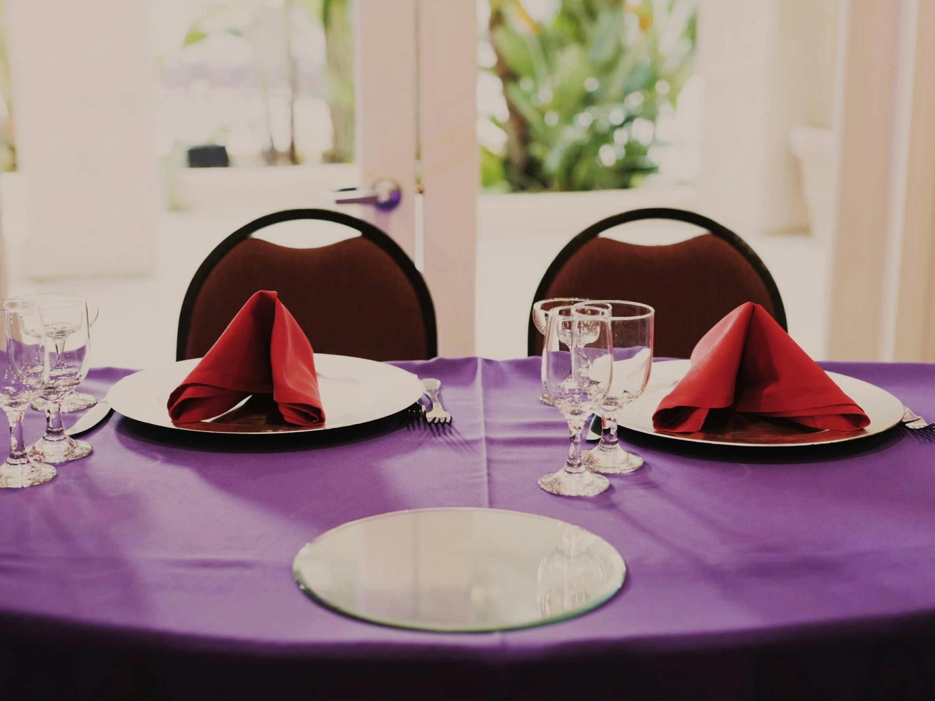 Garden Room wide: dance floor, stage, botanical mural, rounds.